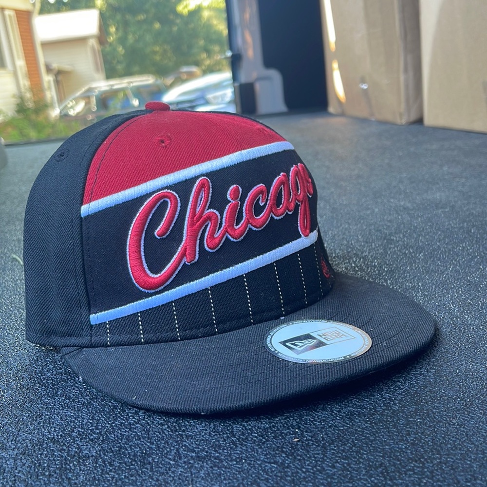 This Chicago Bulls Snapback Hat is new and unused with a green rim!